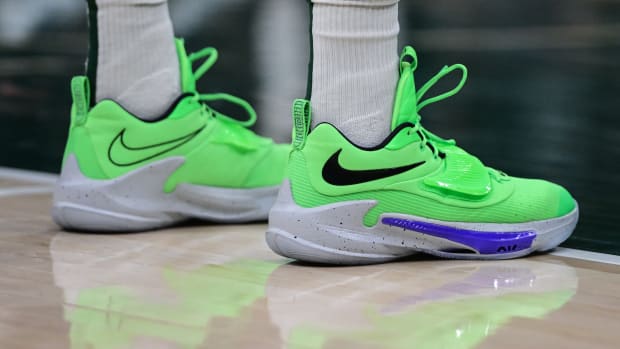 View of Giannis Antetokounmpo's green and grey Nike shoes.